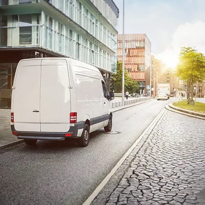 White Ford transit Short weel Base Van driving on a street in north london after being hired out for the day